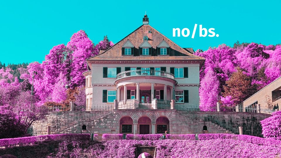 A very old building in an edited photo where the greenery is replaced with purple. The sky is blue.