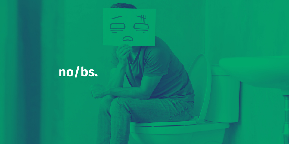 man seat on toilet with sad face paper over his head